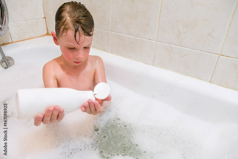 beautiful child taking a relaxing bath with foam and using cosmetics beautiful child taking a relaxing bath with foam and using cosmetics