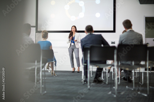Businesswoman giving training to colleagues in conference room photo