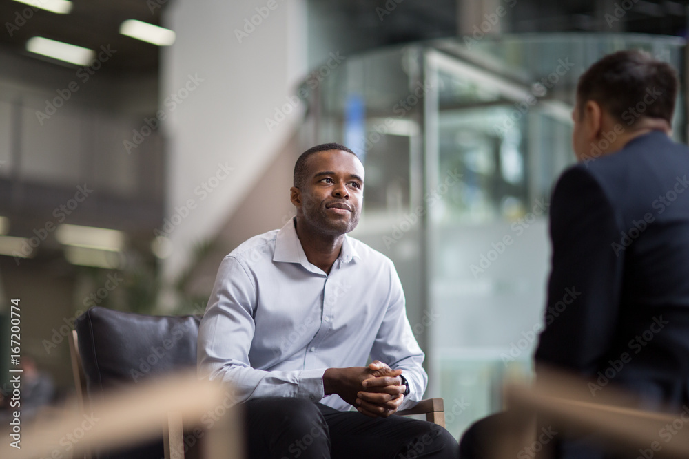 Businessman being asked a question in an interview Businessman being asked a question in an interview