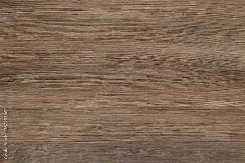 Natural color wooden floor surface. Textured background from woodnut planks. Horizontal grain.