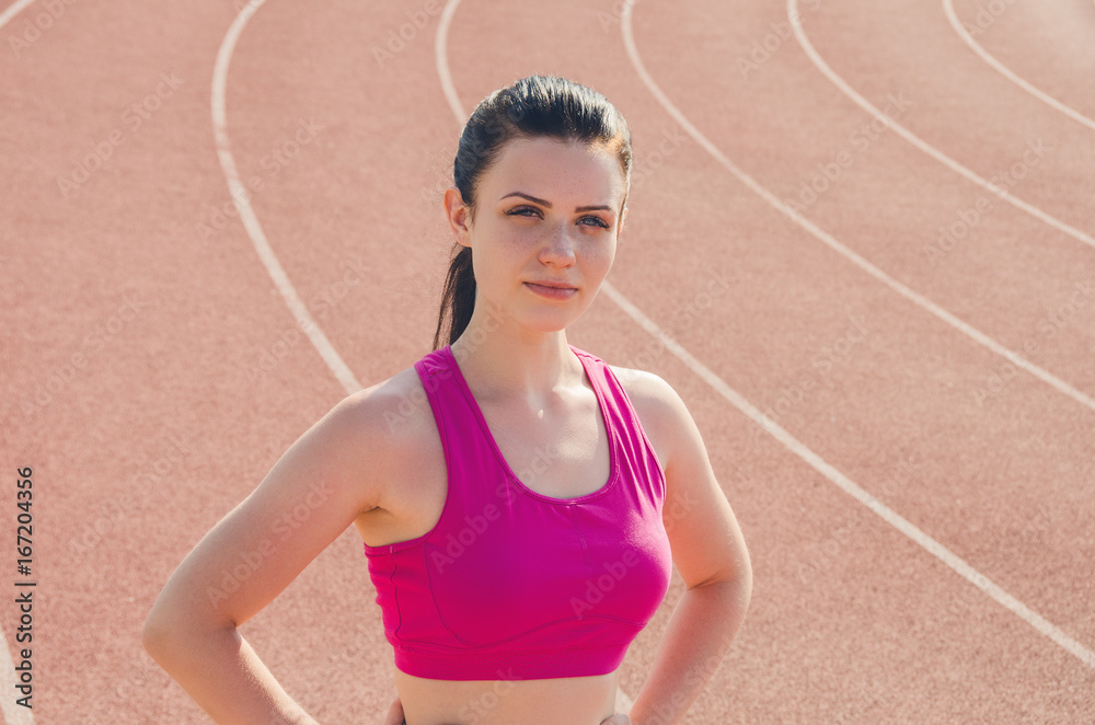 Sport girl workout. Exercise. Fitness. Health. Young girl at stadium do some training and looking at camera. Sport girl workout. Exercise. Fitness. Health. Young girl at stadium do some training and looking at camera.