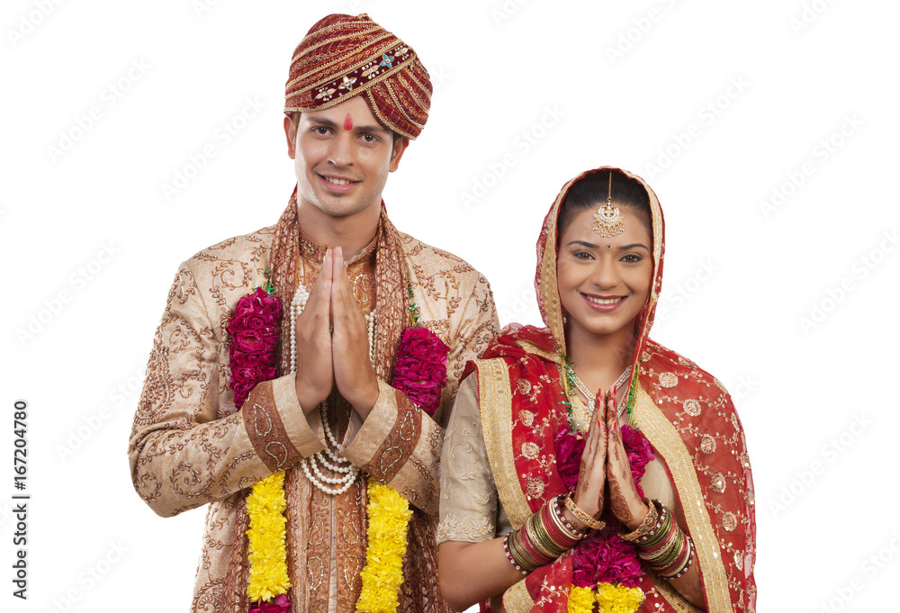Portrait of a Gujarati bride and groom greeting 