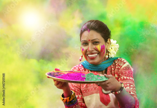 Photography Portrait of a teenage Indian girl celebrating Holi festival with traditional dre