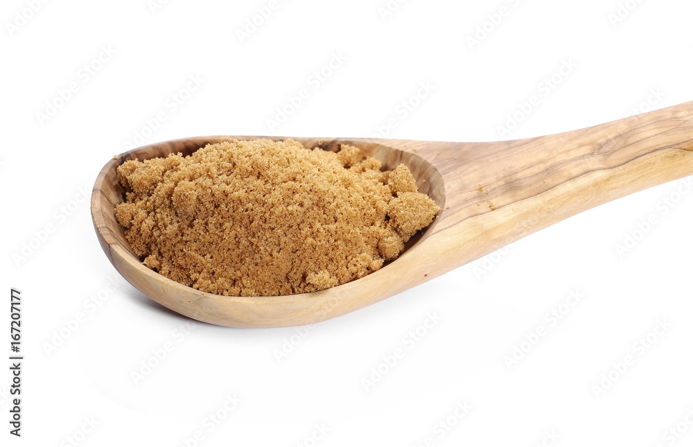 Unrefined light brown cane sugar pile and wooden spoon isolated on white background Unrefined light brown cane sugar pile and wooden spoon isolated on white background
