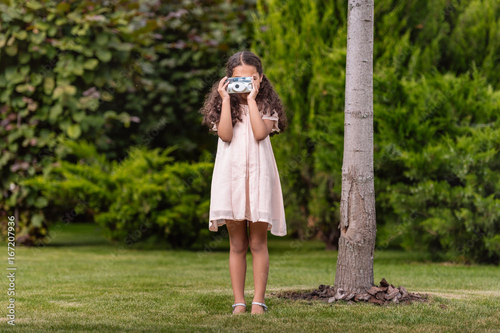 little african american girl taking photo on camera in park little african american girl taking photo on camera in park