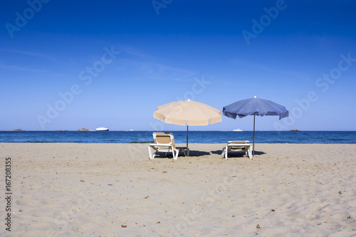 Chairs and umbrellas on a beautiful sandy beach at Ibiza © smuki