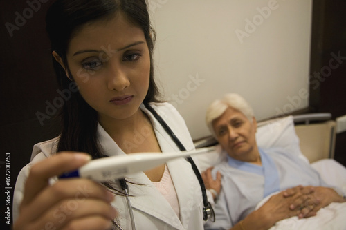 Doctor taking patient's temperature 