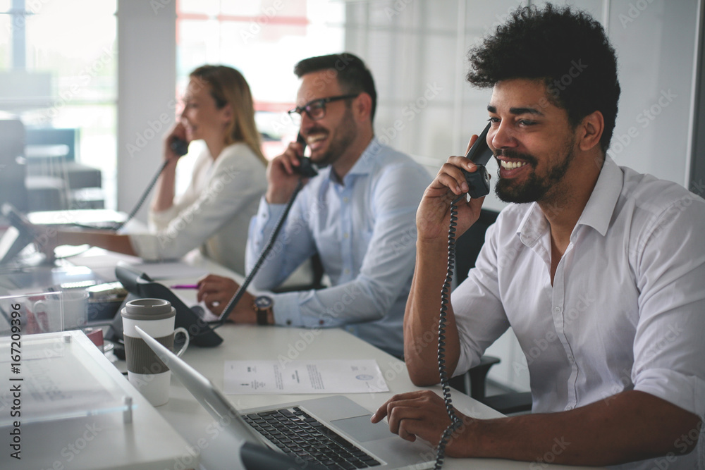 People in operations center talking on Landline phone. Operators in the office. People in operations center talking on Landline phone. Operators in the office.