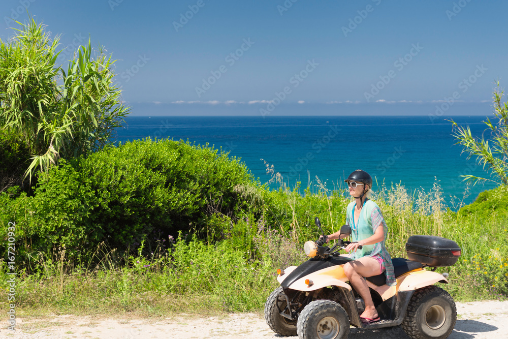 Driving quadbike by the sea