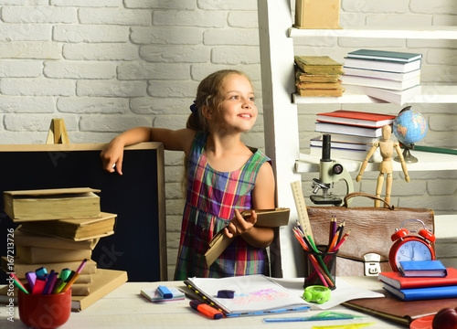 Kid with colorful stationery. Childhood and back to school concept photo