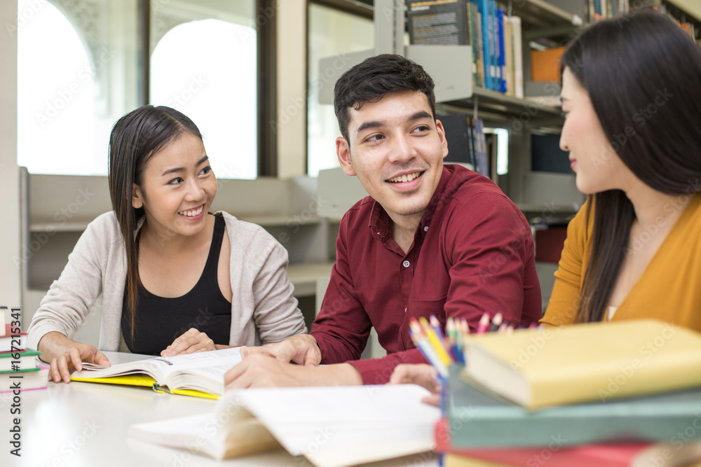 Group of Student reading books in the library with attractive smiling together . People with Education concept. Group of Student reading books in the library with attractive smiling together . People with Education concept.