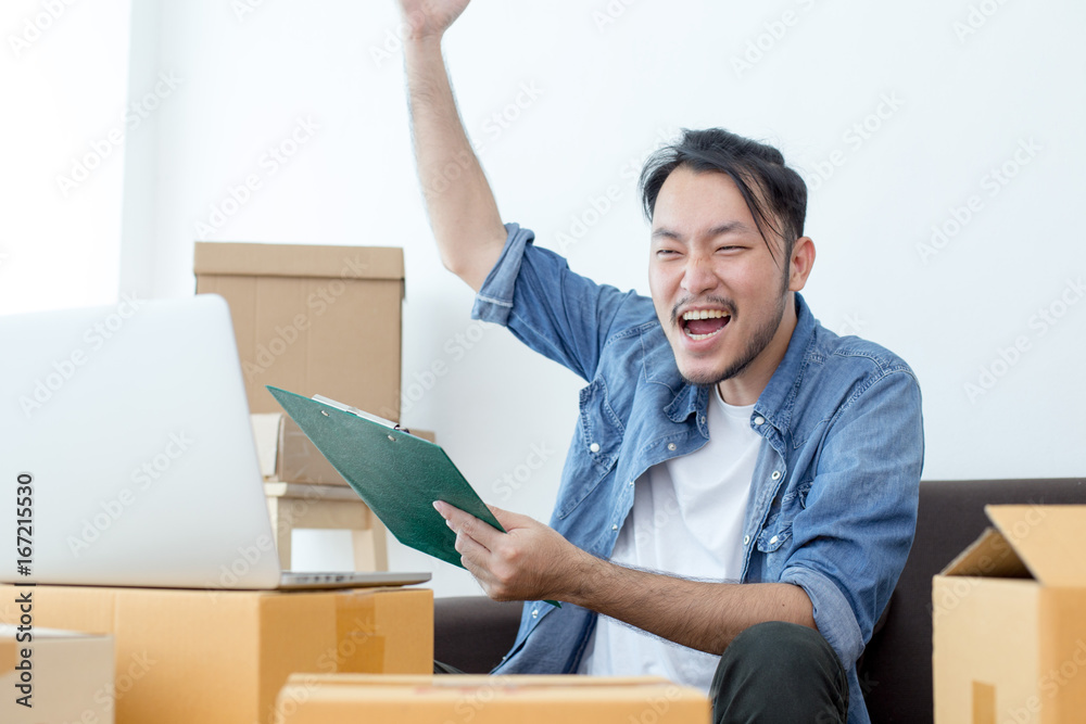 Young Asian Man Working at home, Young Owner Man Start up for Business Online, SME, Delivery Project, Man with Online Business or SME Concept. Young Asian Man Working at home, Young Owner Man Start up for Business Online, SME, Delivery Project, Man with Online Business or SME Concept.
