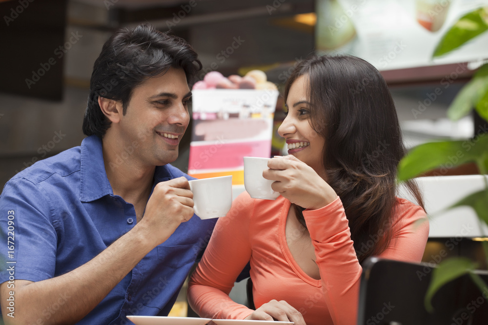 Couple enjoying a cup of tea in shopping mall 