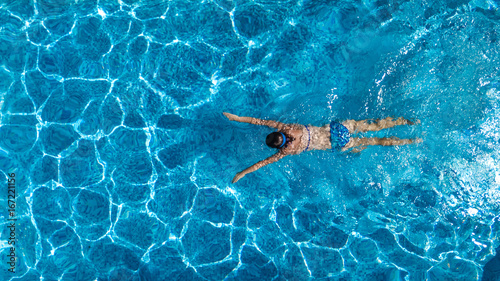 Aerial top view of woman in swimming pool water from above  tropical vacation holaday concept  