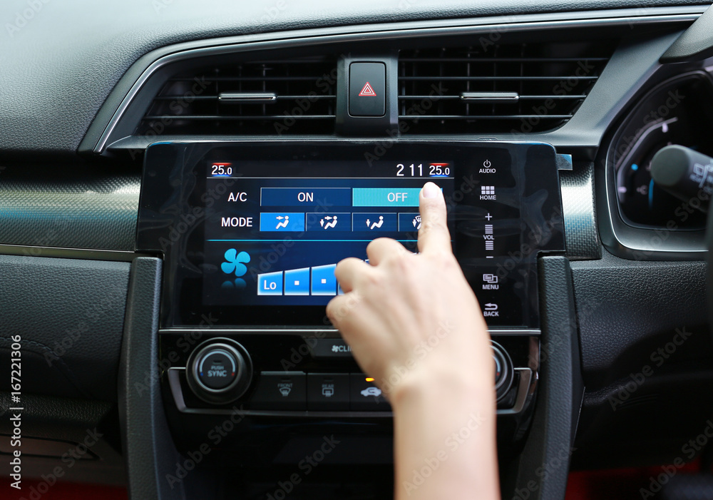 Finger pressing the button off the air conditioner in the modern car dashboard. Finger pressing the button off the air conditioner in the modern car dashboard.