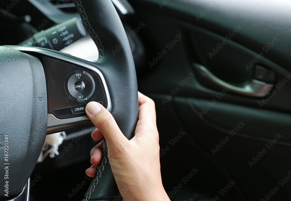 Hand using Cruise control. Hand using Cruise control.
