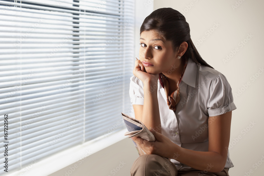 Portrait of confused businesswoman while solving puzzle at office Portrait of confused businesswoman while solving puzzle at office