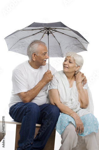 Old couple under an umbrella 