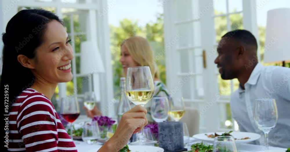Two friends toasting glasses of wine in restaurant Two friends toasting glasses of wine in restaurant