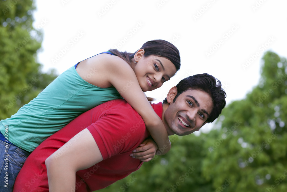 Man carrying woman on back Man carrying woman on back