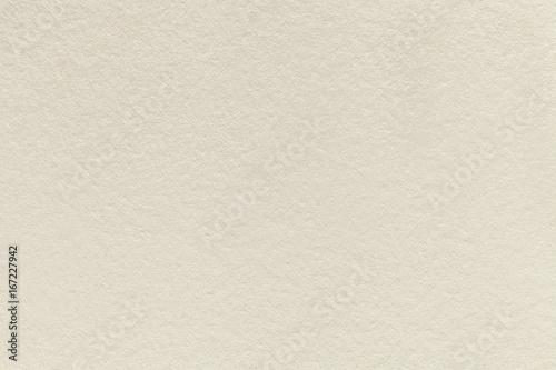Texture of old light beige paper background, closeup. Structure of dense sand cardboard
