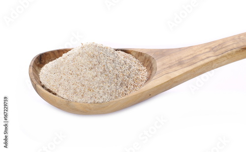 Pile of integral wheat flour in wooden spoon isolated on white