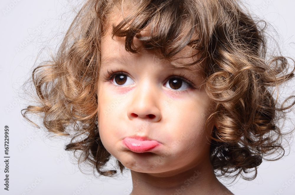 Portrait of a beautiful sad boy. Toddler feeling sadness because he was  disappointed. Adorable boy having different emotions. Kid making funny  faces. Boy with long curly hair. Photos | Adobe Stock
