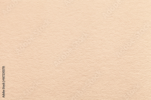 Texture of old light beige paper background, closeup. Structure of dense sand cardboard
