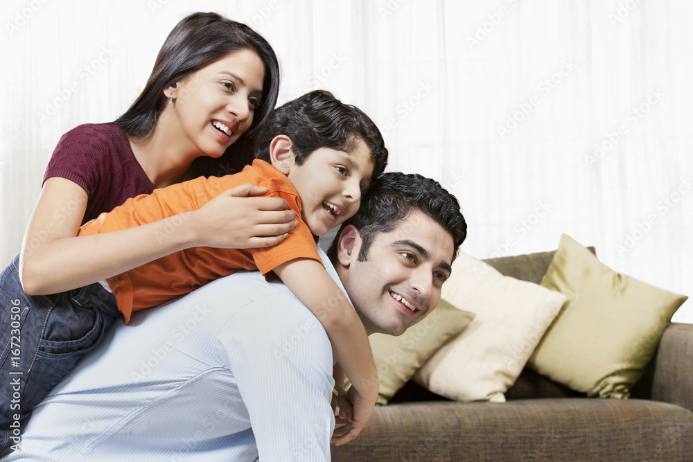 Happy Indian family of three playing at home Happy Indian family of three playing at home