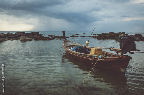 Wooden boats during the cloudy sunset