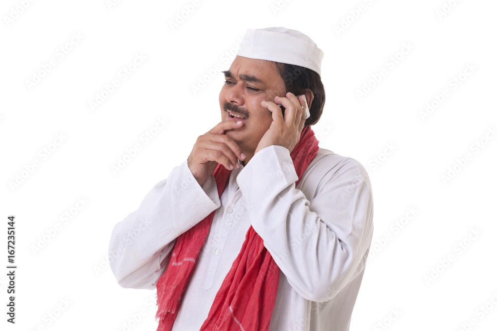 Indian politician thinking while talking on mobile phone Indian politician thinking while talking on mobile phone