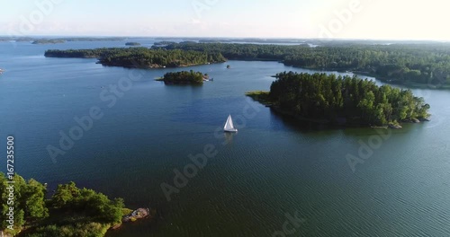 Sailboat in archipelago, Cinema 4k aerial view around a sail boat, in uusimaa saaristo archipelago, on the gulf of finland, on a sunny evening dawn, in Raasepori, Finland photo