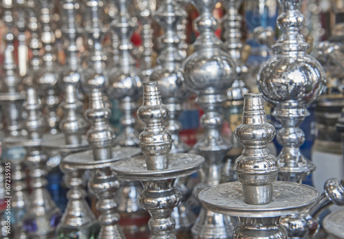 Rows of shisha water pipes in an egyptian market stall