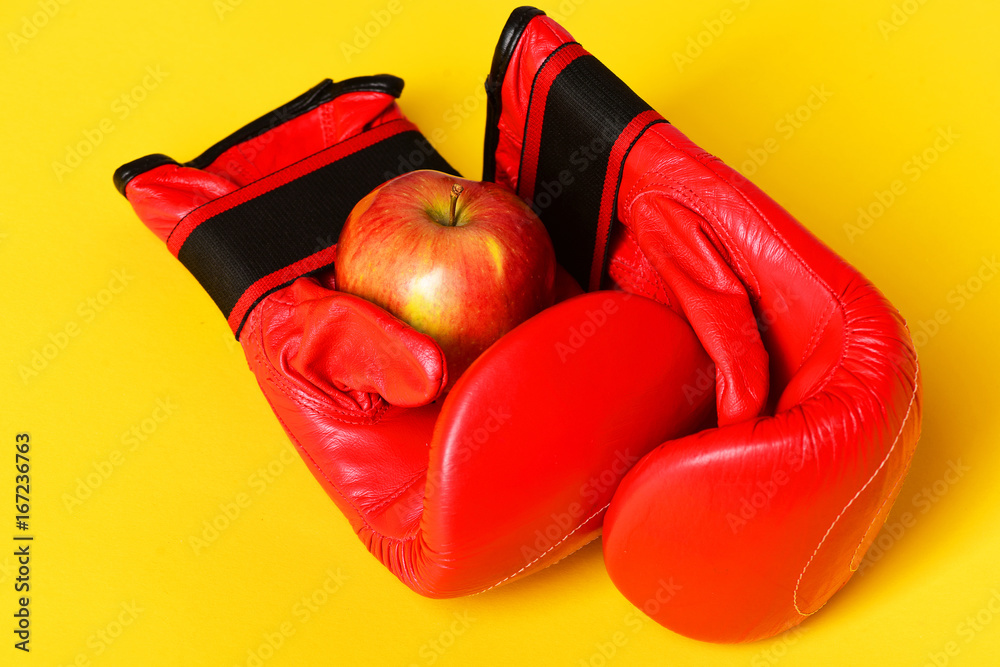 Sport equipment and fruit isolated on striking yellow background