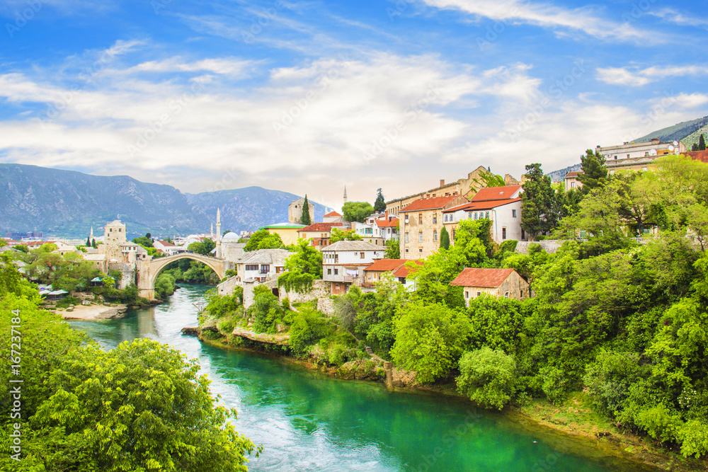 A beautiful view of the old bridge across the Neretva River in Mostar, Bosnia and Herzegovina, on a sunny summer day