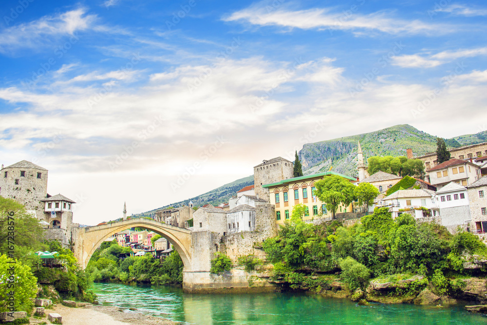A beautiful view of the old bridge across the Neretva River in Mostar, Bosnia and Herzegovina, on a sunny summer day