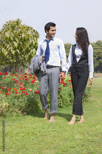 Businessman and businesswoman walking in a park © IndiaPix