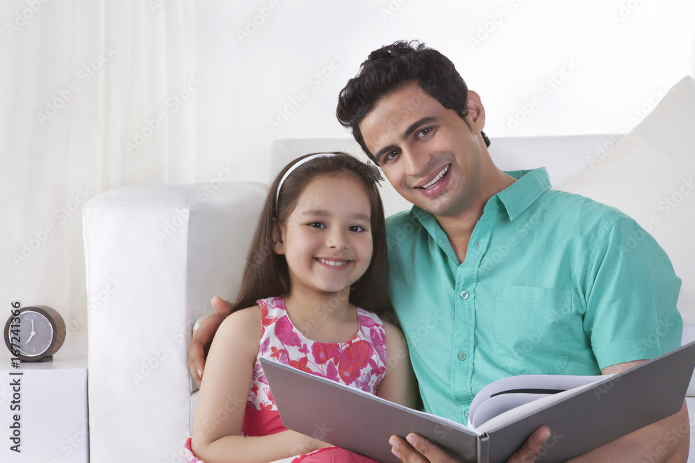 Fototapeta premium Portrait of father and daughter with file at home