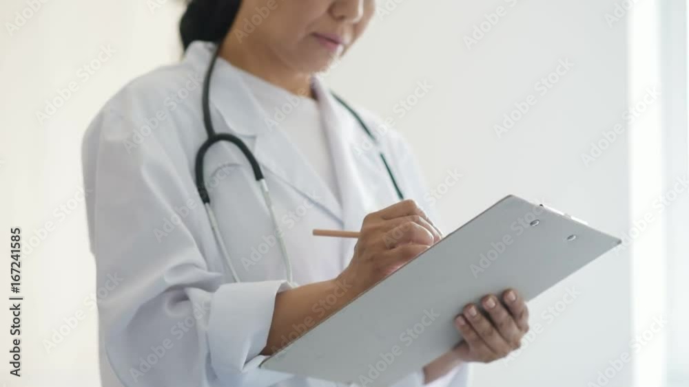 Professional concentrated female doctor making notes Professional concentrated female doctor making notes