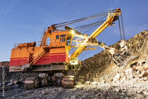 excavator works with granite or ore at opencast mining