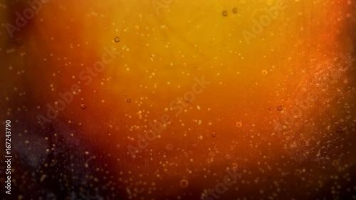 Pouring cola soda into Glass with Bubbles Background