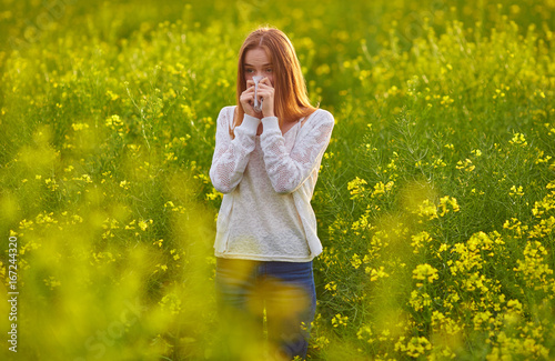 Pollen allergy, girl sneezing photo