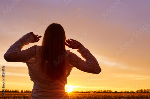 Silhouette of a girl enjoying sunset