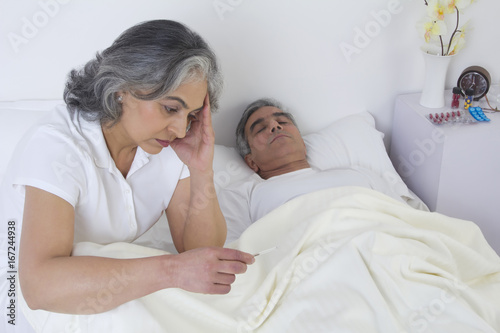 Wife checking husband's fever