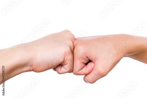 Close-up hands of boy and girl are banging their fists. Fist bump isolated on white background. photo