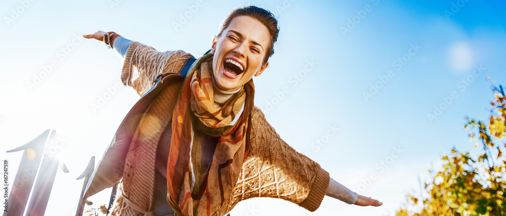 Happy young woman having fun time in autumn outdoors - obrazy, fototapety, plakaty 