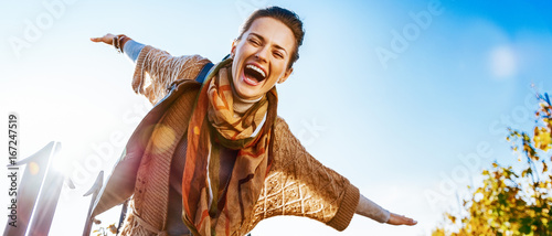 Happy young woman having fun time in autumn outdoors