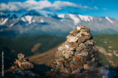 Stone landmark on Landmannalaugar trek and snow mountains beyond photo