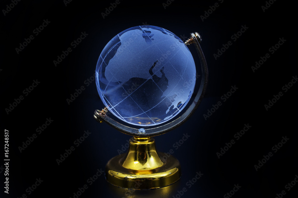 Glass globe model gold stand on black table background Glass globe model gold stand on black table background