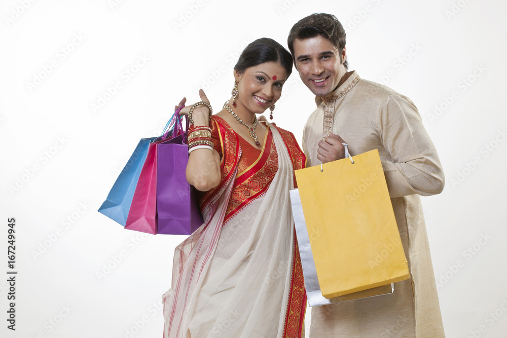 Portrait of a Bengali couple with shopping bags Portrait of a Bengali couple with shopping bags